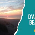 Sunset view over Cap d’Agde Naturist Beach with sand dunes and sea in the background.